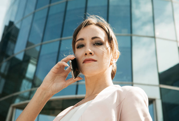 Business, people, tehnology concept: Business Woman With Phone Near Office. - Φωτογραφία, εικόνα