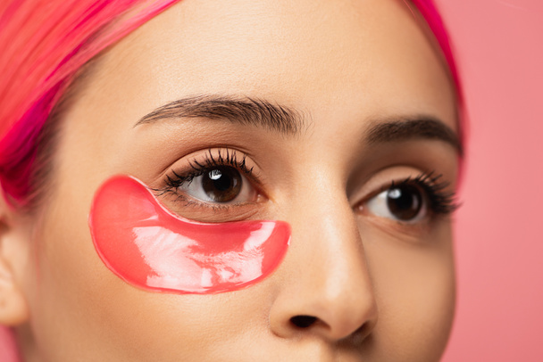 partial view of young woman with dyed hair and collagen eye patch isolated on pink  - Φωτογραφία, εικόνα