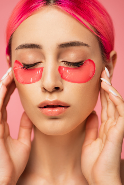 young woman with closed eyes and collagen eye patches isolated on pink  - Foto, Imagem