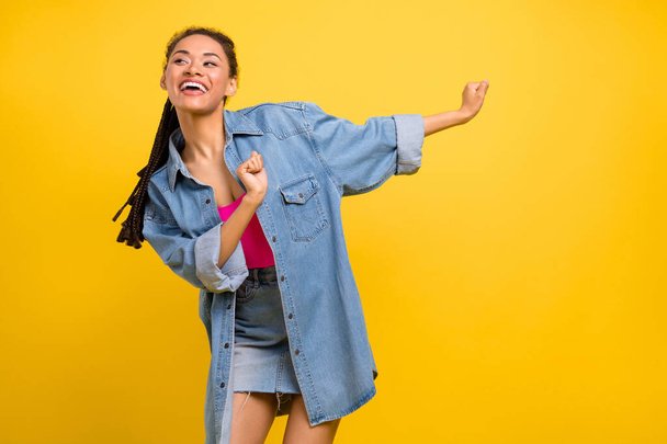 Photo of young afro girl happy positive smile dance party excited isolated over yellow color background - 写真・画像