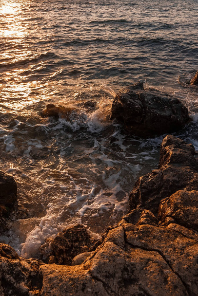 Rocky seashore. Natural background. Summer evening on the beach. - 写真・画像