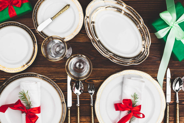 Brown wooden table with beautiful Christmas table setting - 写真・画像