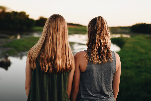 A back view of female friends with different blond hair textures - Fotó, kép
