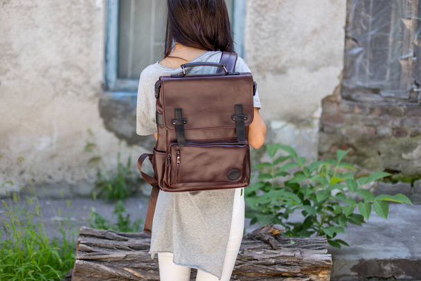 Back of woman with brown leather backpack. Unisex bag for sale. Unbranded backpack. - Photo, Image
