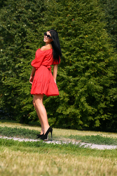 Beautiful woman in red dress  - Фото, изображение