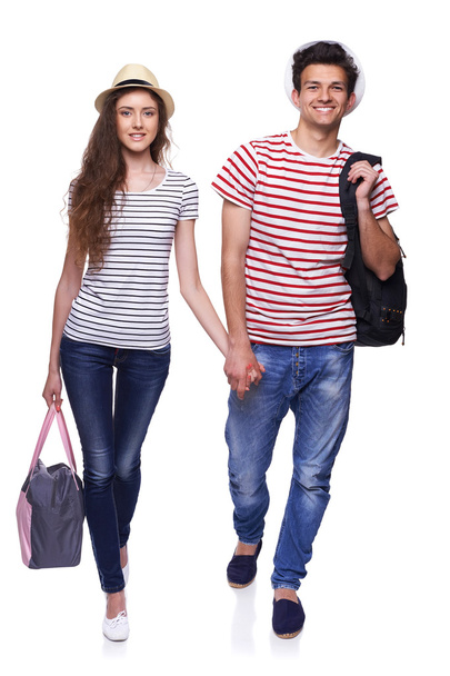 Young couple walking with travel bags - Fotoğraf, Görsel