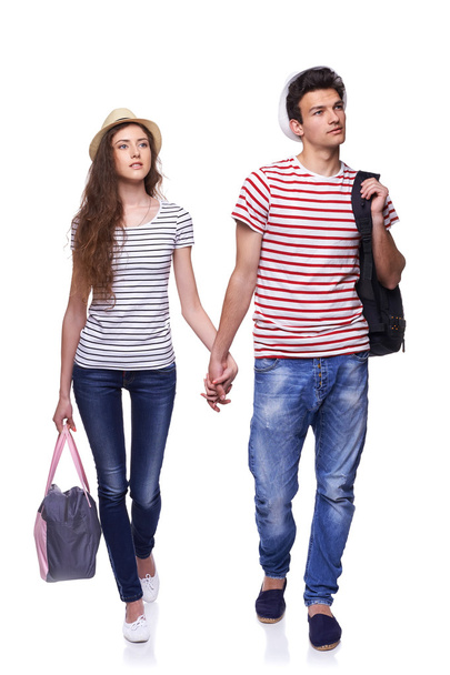 Young couple walking with travel bags - Foto, imagen