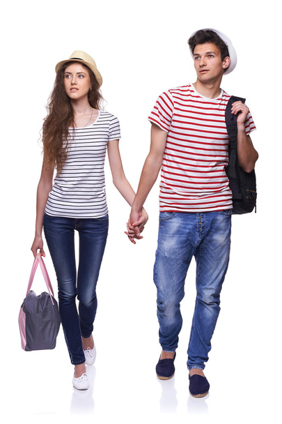 Young couple walking with travel bags - Valokuva, kuva
