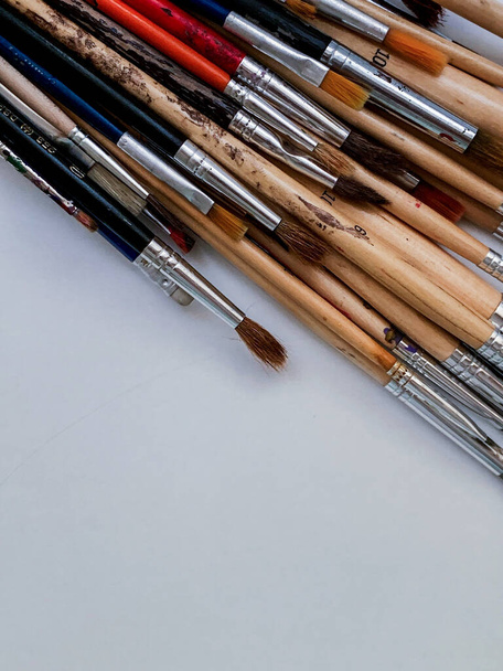 A vertical shot of wooden paintbrushes on a white background - Photo, Image