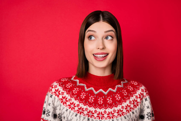 Photo of charming dreamy young woman dressed prink pullover smiling looking empty space isolated red color background - Foto, Bild