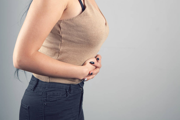 a young woman has a stomach ache - Φωτογραφία, εικόνα