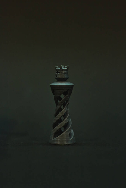 A vertical shot of decorative queen chess isolated on black background - Foto, afbeelding