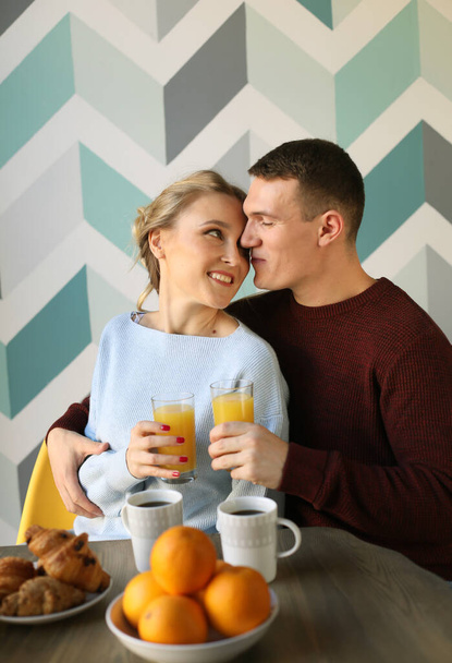 Lifestyle and people concept: Young happy lovely couple have breakfast in the early morning at home, hug, smile. - Foto, immagini