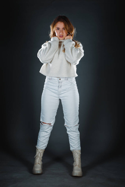 現代風ふわふわセーターを身に着けている流行の若い女性のスタジオボディショット - 写真・画像