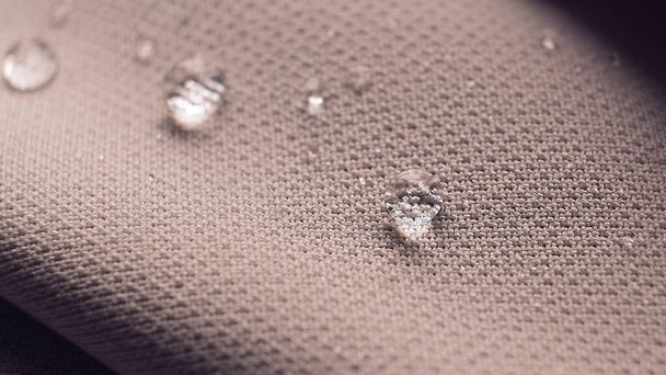 water beading on fabric. Waterproof coating background with water drops. soft focus, blur - Photo, Image