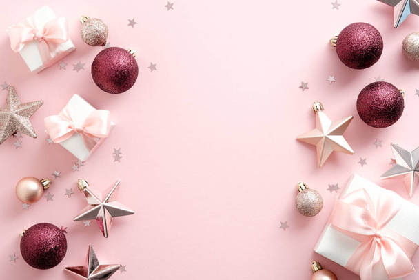 Stylish Christmas decorations on pastel pink background. Christmas frame. New Year banner mockup. Flat lay, top view. - Foto, Imagen