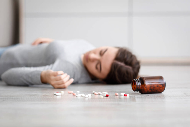 Female with pile of antidepressants kill herself, commit suicide, suffer from mental distress - Φωτογραφία, εικόνα