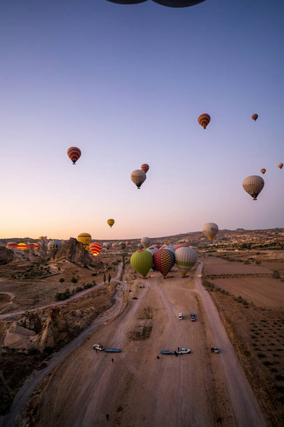 Cappadocia, Törökország - 2021. szeptember 14.: Kora reggel hőlégballonok függőleges fellövése a gorémnemzeti park körül - Fotó, kép