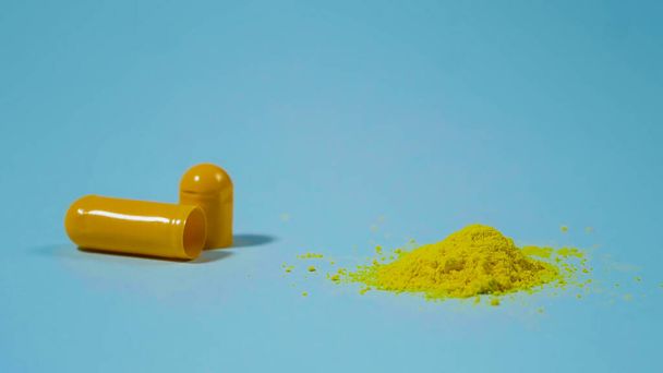 Powder of pills. Yellow medicine from a capsule. Pharmaceutical Concept. - Photo, Image