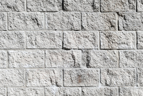Detail of a rough gray stone block wall - 写真・画像