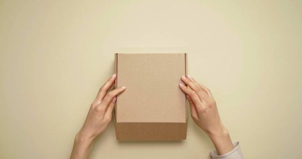 Hand of a woman who is opening a box - Photo, Image