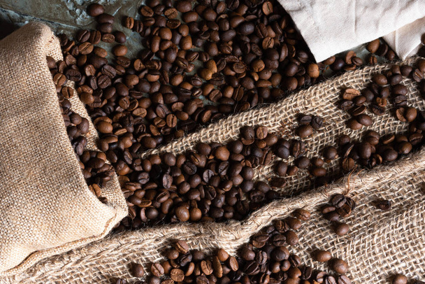 Coffee beans and grinder on table with rustic background - Foto, immagini