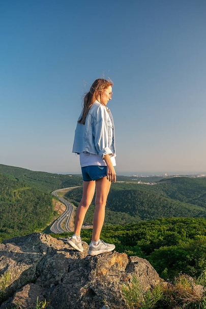 Girl in shorts on the top of the mountain - Φωτογραφία, εικόνα