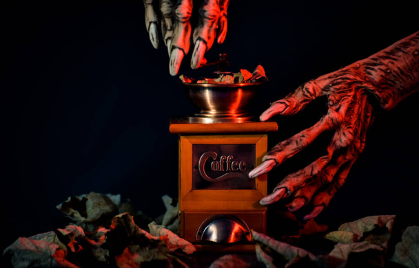 Halloween still life with monster paws and coffee grinder - Photo, Image