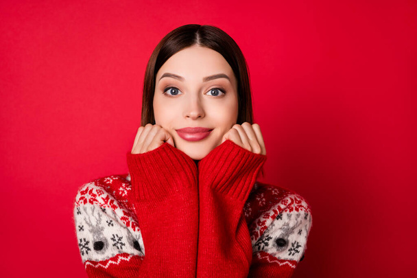 Photo of charming adorable young lady wear print sweater arms cheeks smiling isolated red color background - 写真・画像