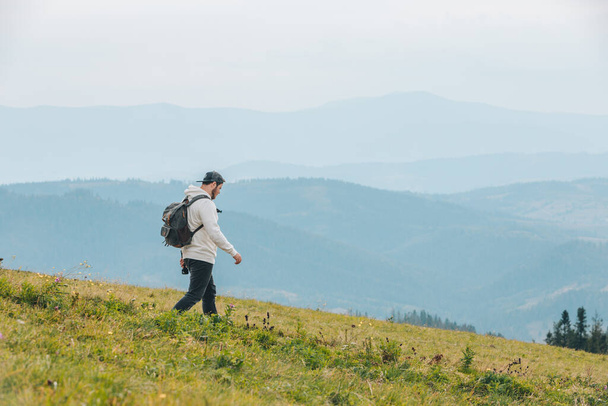 man with backpack hiking in mountains autumn season - Foto, imagen