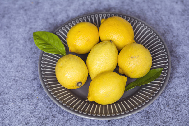 Fresh Yellow Lemons in a Dish .Top View. - Zdjęcie, obraz