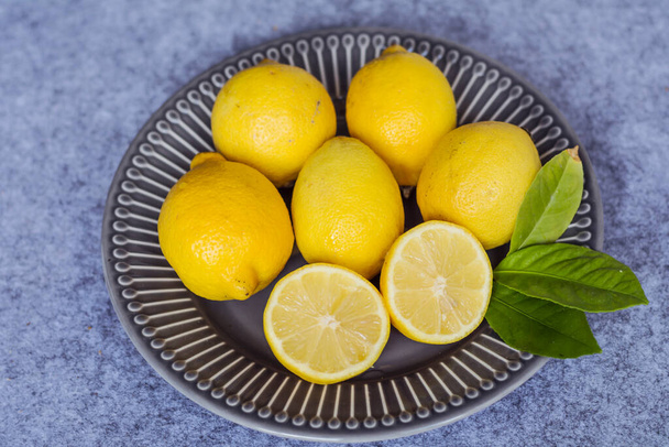 Fresh Yellow Lemons in a Dish .Top View. - Zdjęcie, obraz