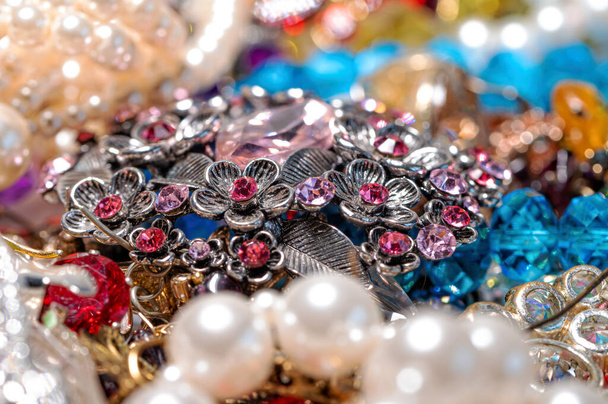 abstract background from various colorful bright jewelry and costume jewelry, soft, selective focus - Foto, Bild