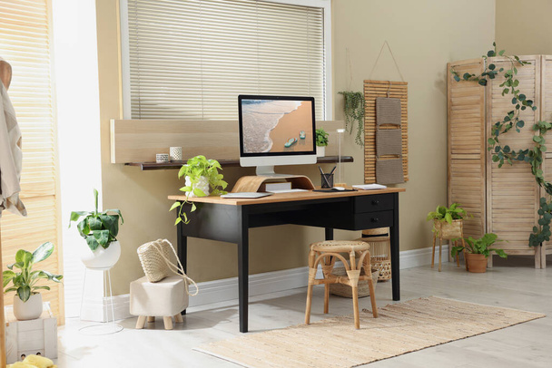 Light room interior with comfortable workplace near window - Photo, image