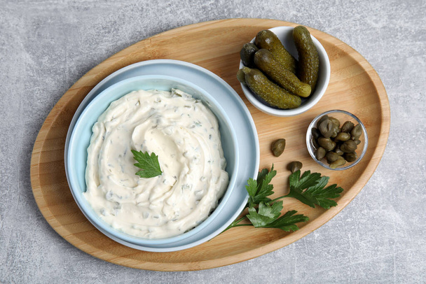 Tasty tartar sauce and ingredients on grey table, top view - Photo, Image