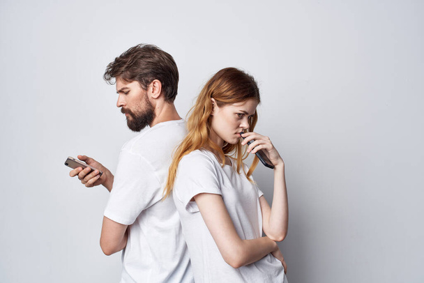 hombre y mujer familia con teléfonos en la mano estudio de comunicación estilo de vida - Foto, Imagen