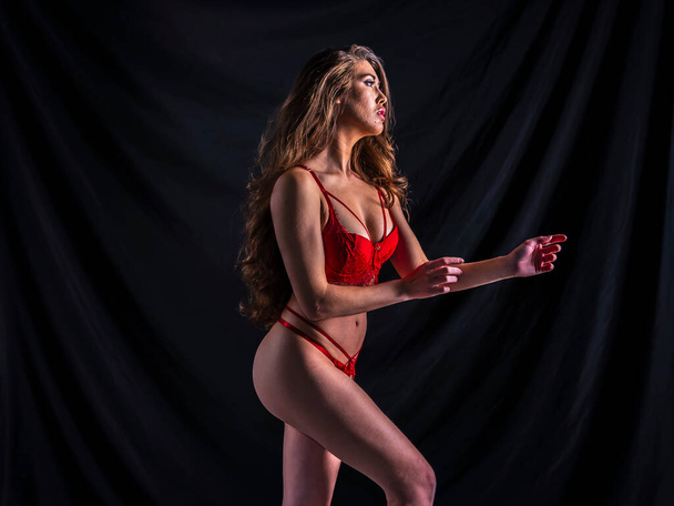 Una bella modella mista di lingerie da corsa in posa in un ambiente da studio - Foto, immagini