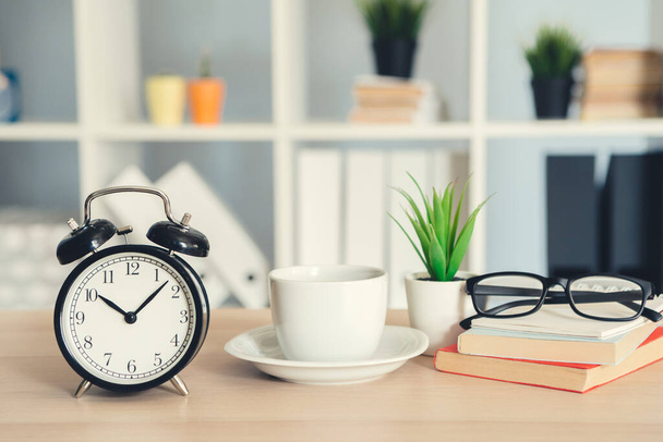 Classic vintage alarm clock and coffee cup on wooden background - Φωτογραφία, εικόνα