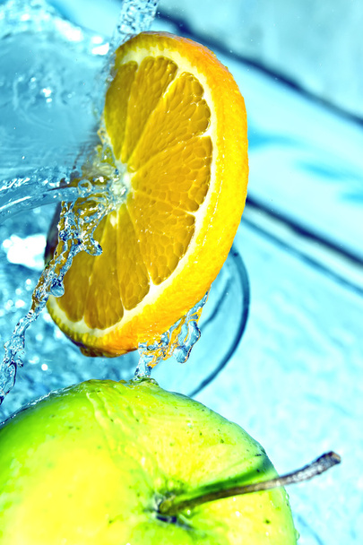 Orange and apple in water splash - Photo, image