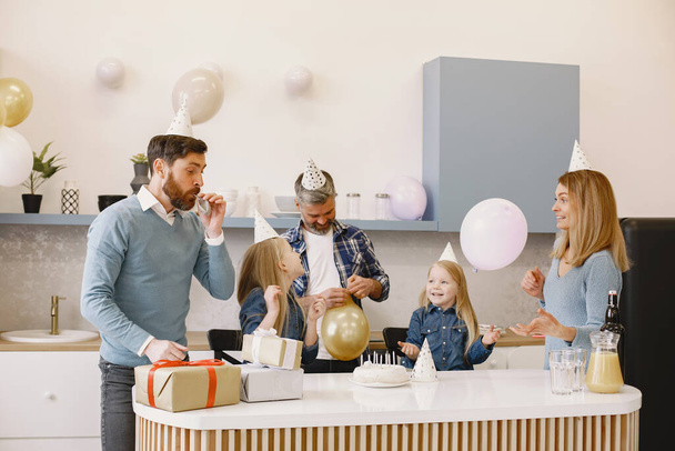 Family celebrating birthday in the kitchen - Photo, Image