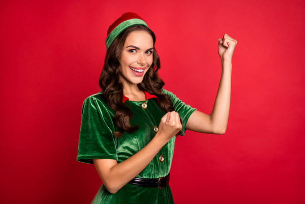 Photo of excited lady raise fists rejoice triumphant win wear elf costume hat isolated red color background - Foto, Imagem