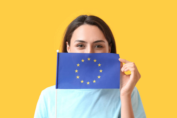 Młoda kobieta z flagą Unii Europejskiej na tle koloru - Zdjęcie, obraz