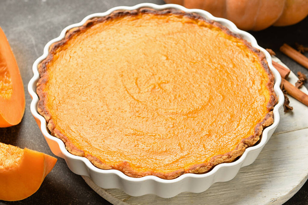 Baking dish with tasty pumpkin pie on black background - Photo, Image
