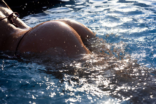Summer butt, sexy buttocks. Sexy woman in swimming pool. Swimwear model. Summer Vacation. Girl in bikini relax. - Foto, Imagem