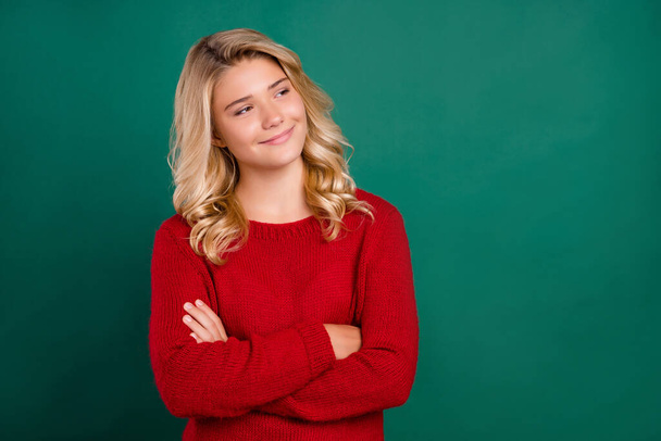 Photo of young pretty girl happy positive smile crossed hands look empty space curious isolated over green color background - Fotografie, Obrázek