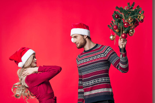 cheerful young couple christmas holiday red background decoration - Foto, Imagem