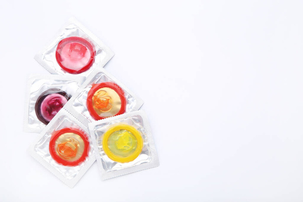 Colorful condoms on white background - Photo, Image