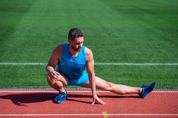 athletic muscular man stretching muscules before workout, training - Valokuva, kuva