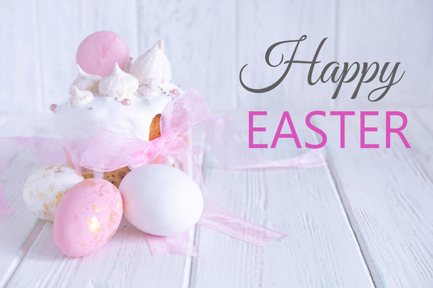 Greeting Easter card. Easter cake, eggs with a congratulatory inscription on a light wooden background. - Foto, immagini
