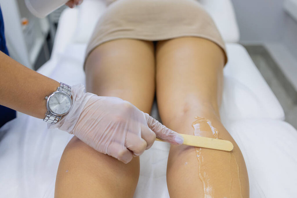 Beautician Giving Epilation Laser Treatment To Woman On Thigh. - Φωτογραφία, εικόνα